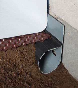 Closeup of a crawl space drainage system installed in Vineland