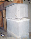 Concrete crawl space support posts in New Castle that are showing signs of failure as they sink into the earth.