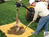Auguring a hole in the earth for a foundation repair in Villanova