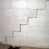 A diagonal stair step crack along the foundation wall of a New Castle home