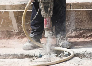 Jackhammering a slab floor in a Bensalem home.
