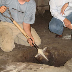 Digging a hole for the engineered fill used in a crawl space support system installation in Cherry Hill