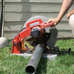 Cutting the support beam for a crawl space jack post outside a Vineland home.