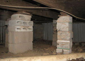 crawl space repairs done with concrete cinder blocks and wood shims in a New Castle home