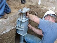 Foundation repair contractors installing the foundation bracket in Reading.