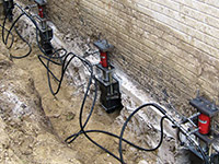 Using foundation push piers to lift a foundation during a repair in Chester.