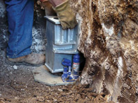 Securing a foundation footing bracket for a foundation repair system in Drexel Hill.