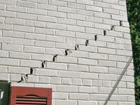 Stair-step cracks showing in a home foundation in Trenton