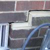 A closeup of a failed tuckpointing job where the brick cracked on a Drexel Hill home.