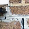 Failed crack repair showing old tuckpointing that cracked on a Reading home.