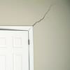 A long drywall crack beginning at the corner of a doorway in a Philadelphia home.