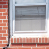 A gap in a window along the outer wall due to foundation settlement of a Quakertown home.