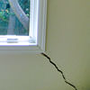 A long, diagonal crack that begins at a window corner of a Kennett Square home