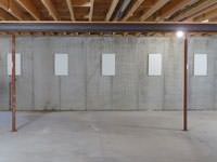 A repaired basement wall with foundation wall anchor covers installed in Bensalem.