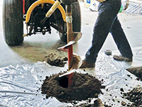 Digging the hole used for wall anchor installation in Newark.