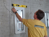 Positioning a wall plate cover on a foundation wall in Cherry Hill.