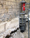 A completed installation of foundation push piers lifting a foundation in Merion Station