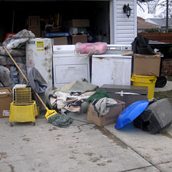 Soaked, wet personal items sitting in a driveway, including a washer and dryer in Cherry Hill.