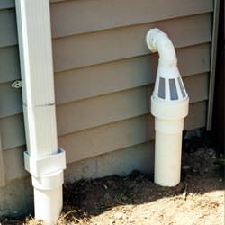 A grated sump pump discharge line fitting in Trenton