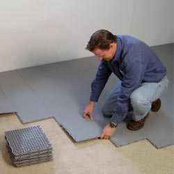 basement subfloor tiles being installed by a contractor in Wilmington