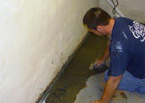 Restoring a concrete slab floor with fresh concrete after jackhammering it and installing a drain system in Wilmington.