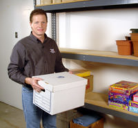 A Philadelphia Basement Systems waterproofer installing a basement drain for a dry space
