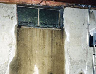 Water pouring out from a basement window in Camden